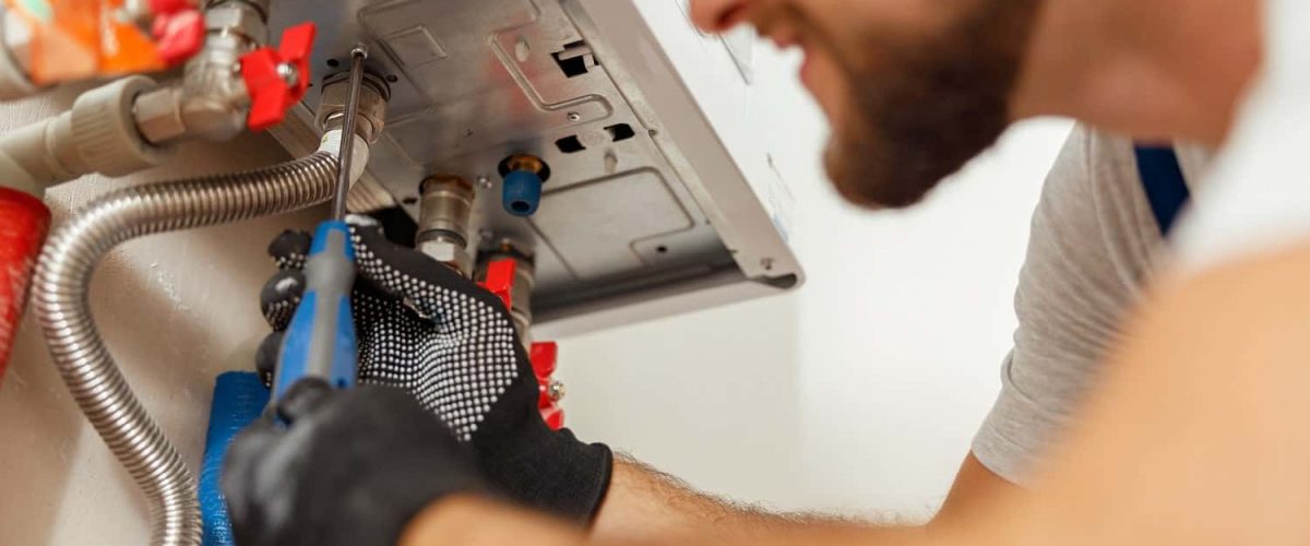 closeup-of-plumber-using-screwdriver-while-install-2022-03-09-03-07-35-utc-min-min.jpg